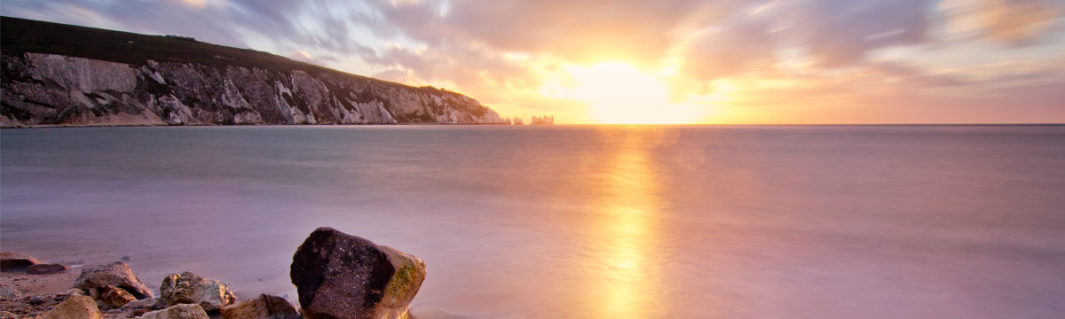 A view of Alum Bay at sunset, looking out to The Needles
