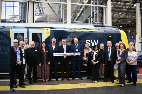Group of people standing in front of Class 450 at Waterloo Station