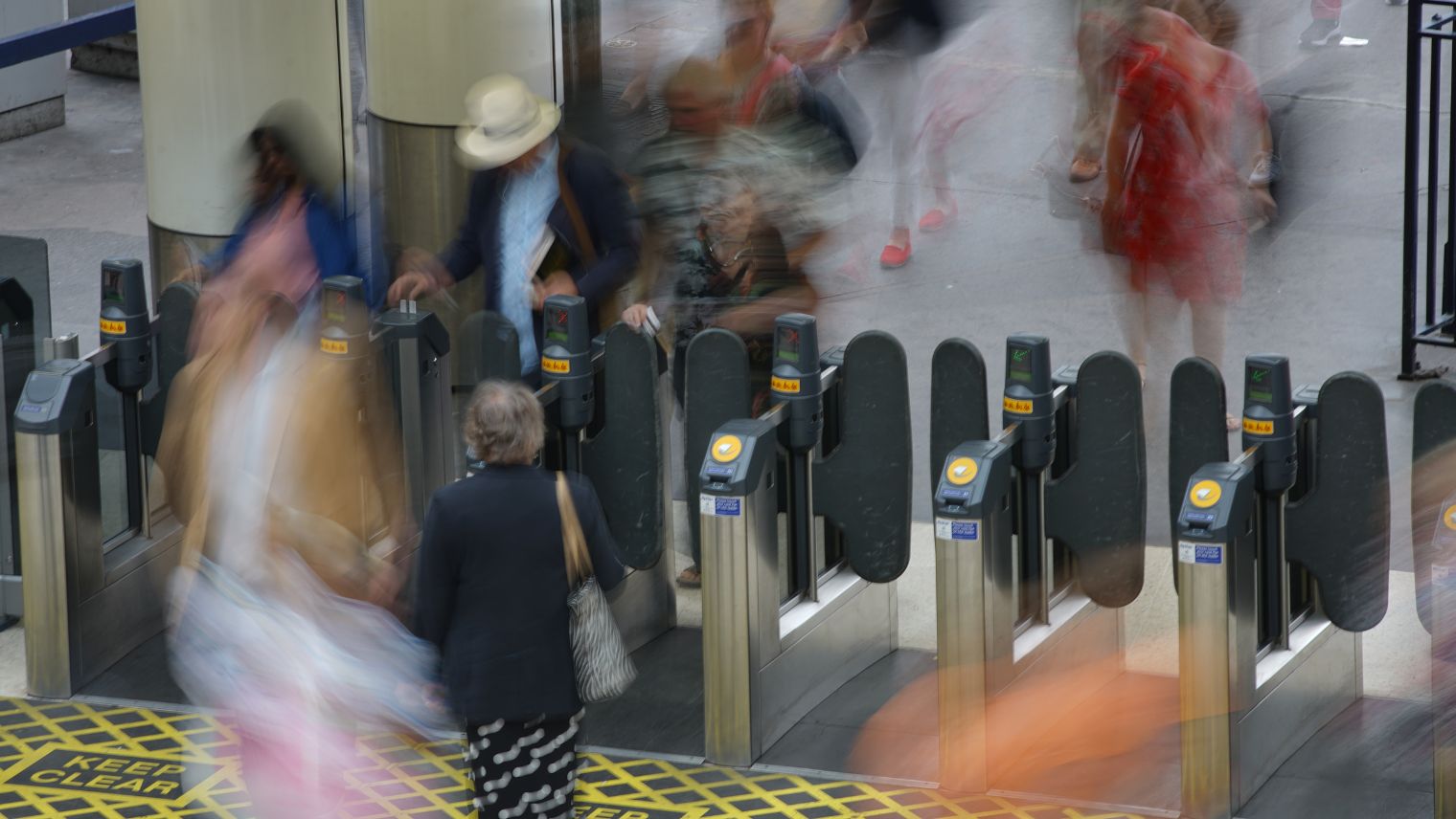 Customers passing through ticket gates at Waterloo