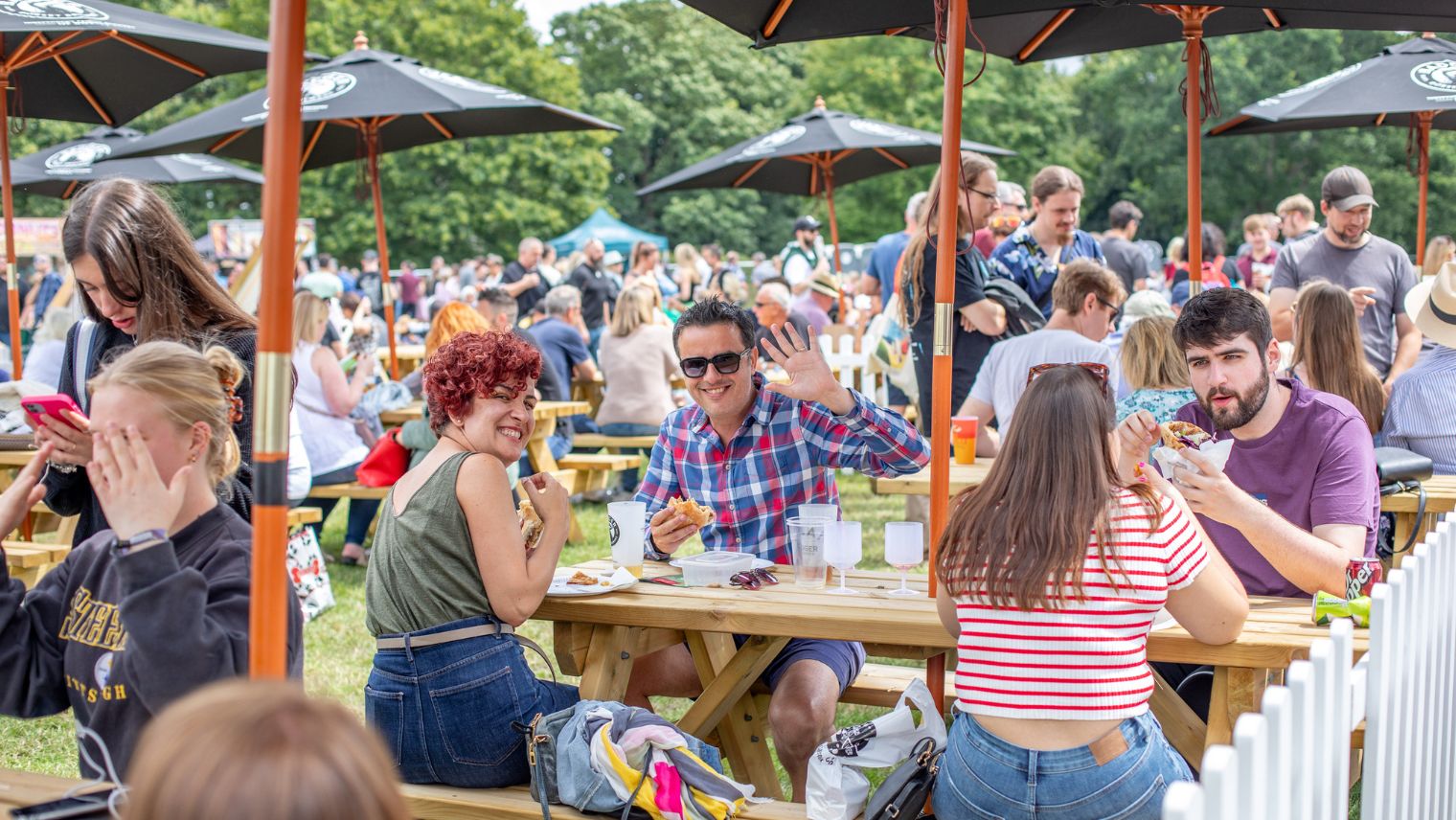 People sitting at an outside table while eating