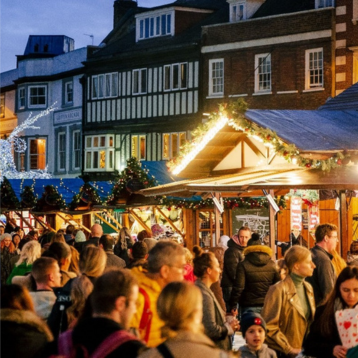 A crowd of people outside at Christmas time