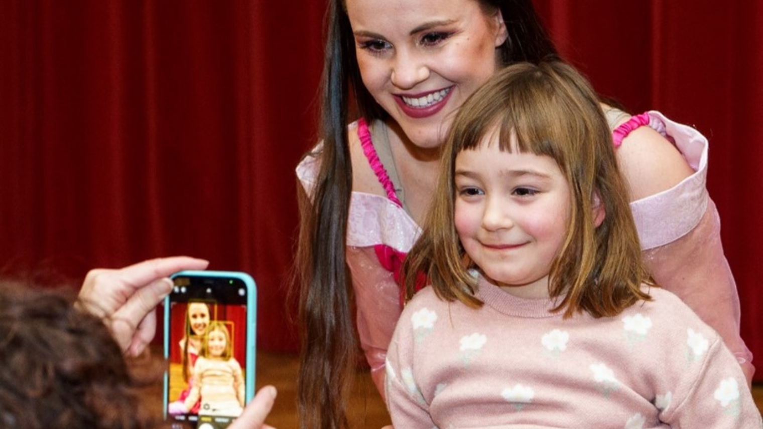 A photo being taken of two people smiling