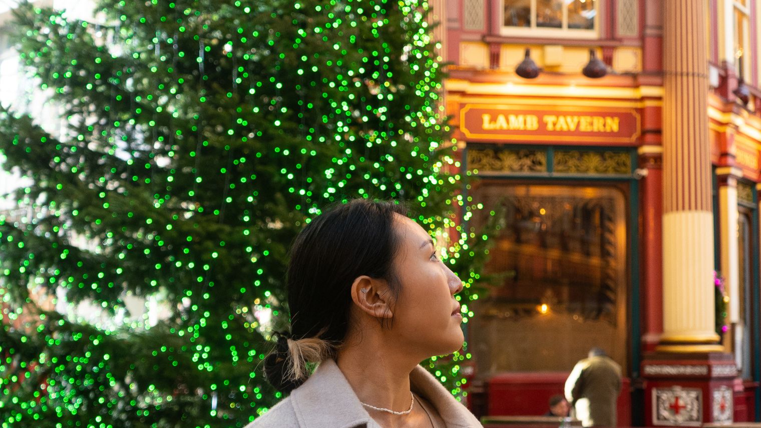 A woman infront of Christmas tree in :Leadenhill Market