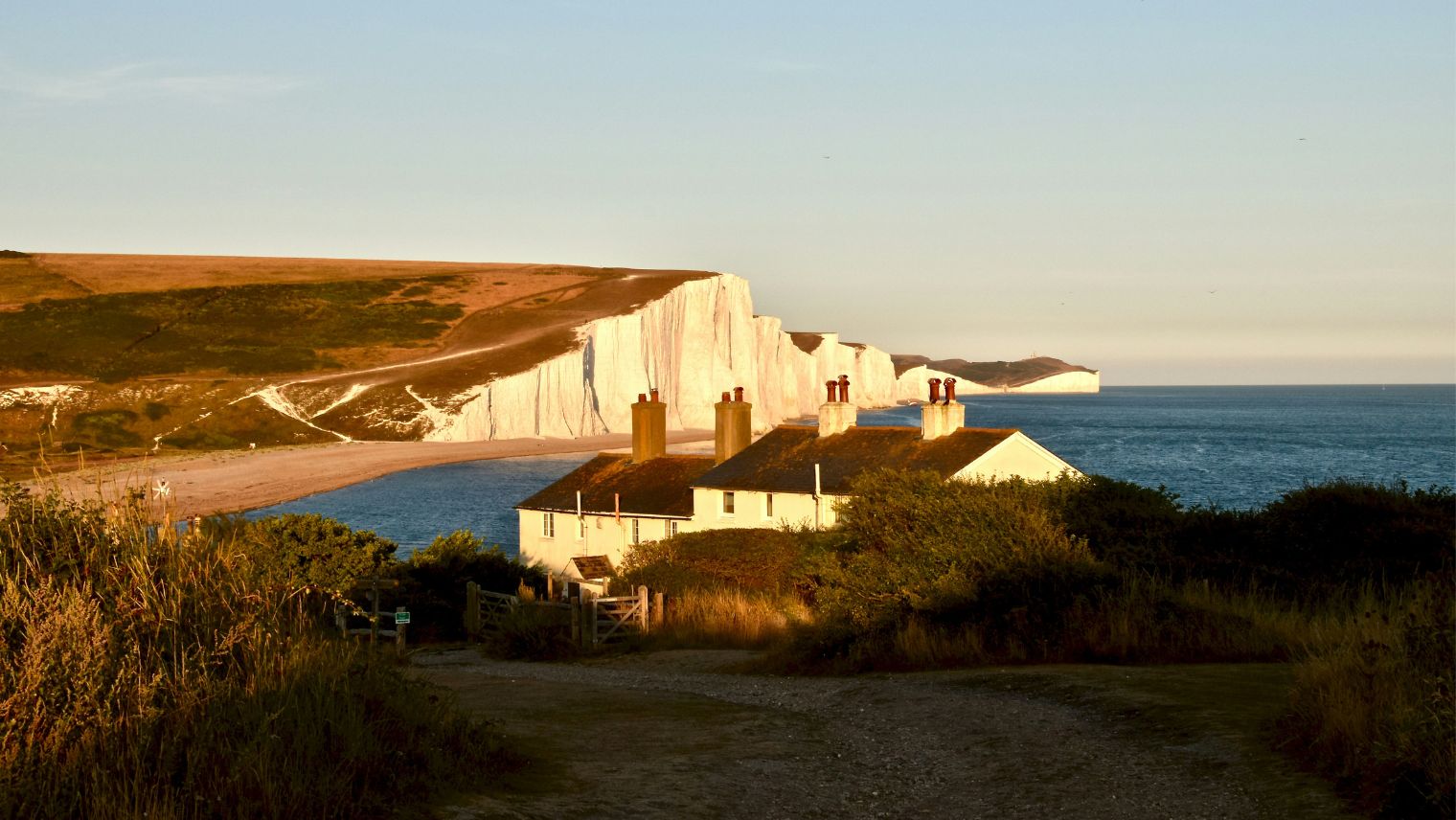 Photo of Seaford Head  with house in the foreground and white cliffs in the background