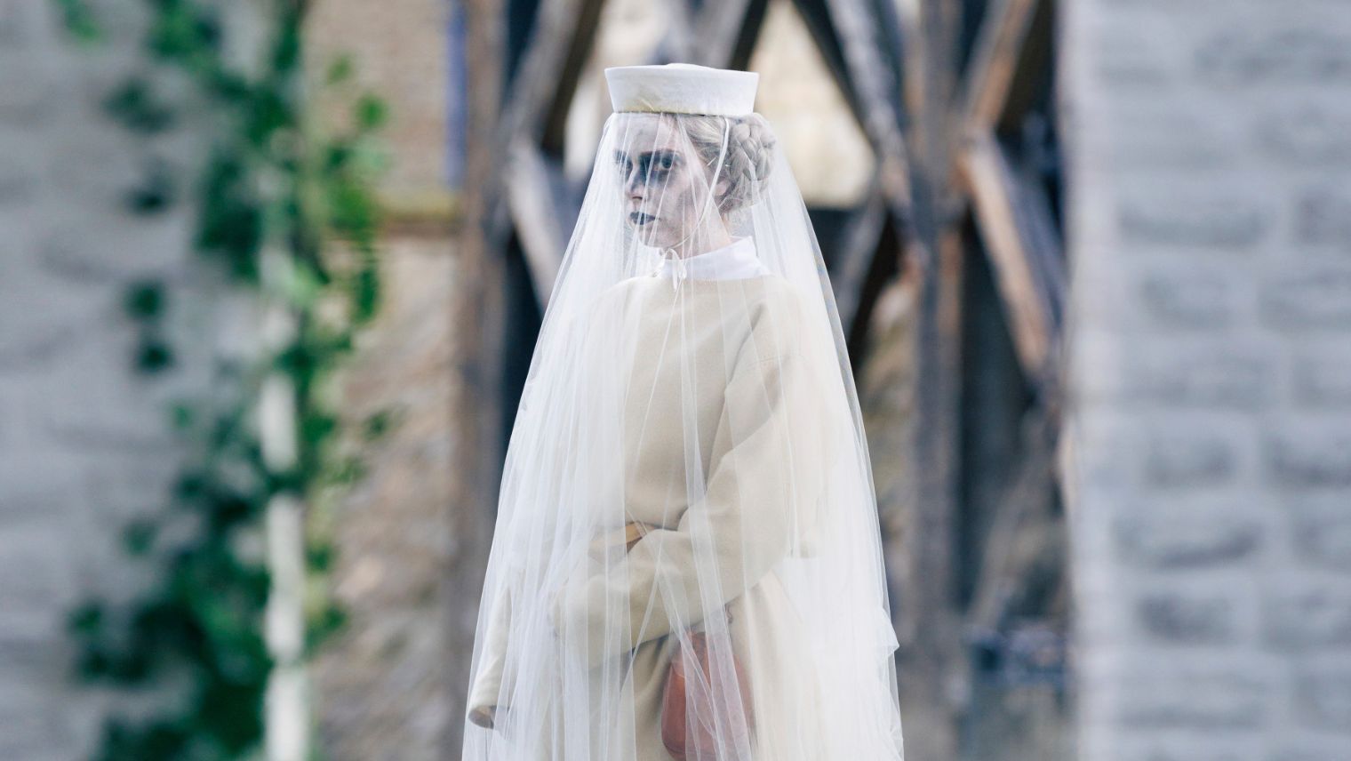 A ghostly figure of a woman in white in the ground of the Tower of London