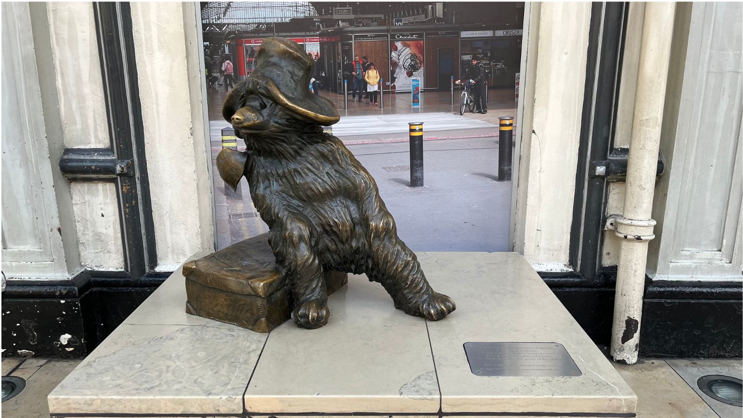 A metal statue of Paddington Bear in Paddington Station London