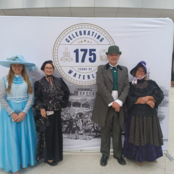 4 people standing in front of a sign that says: 'celebrating 175'